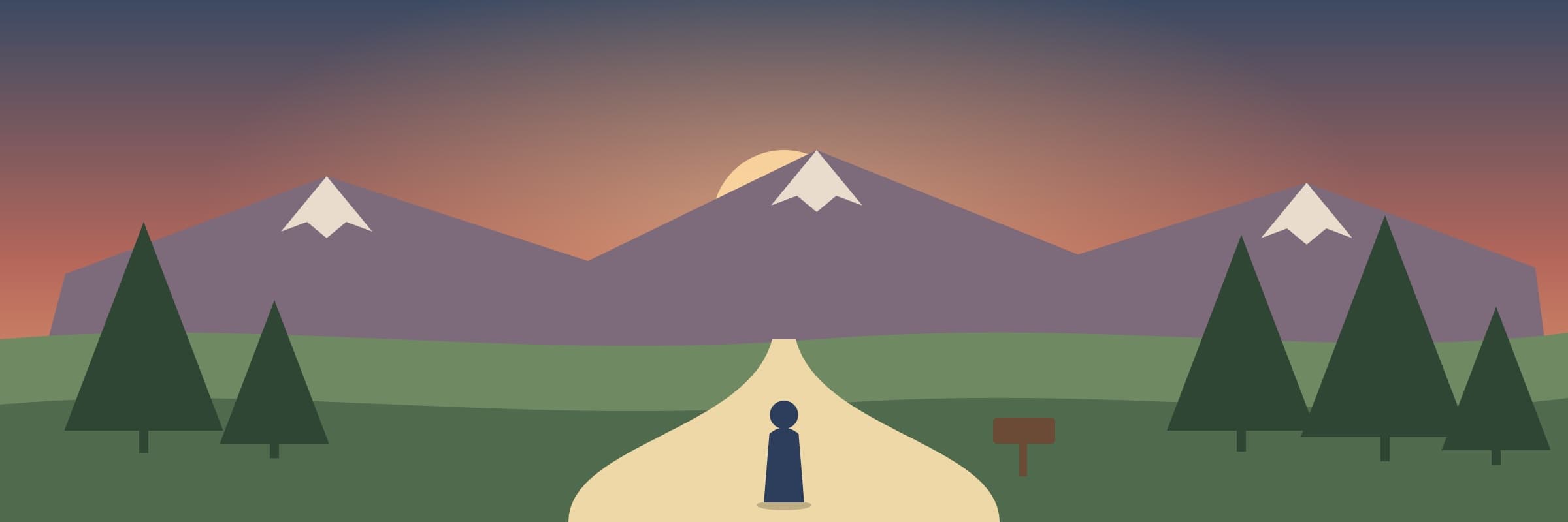 A trail leading toward snow-capped mountains at sunset